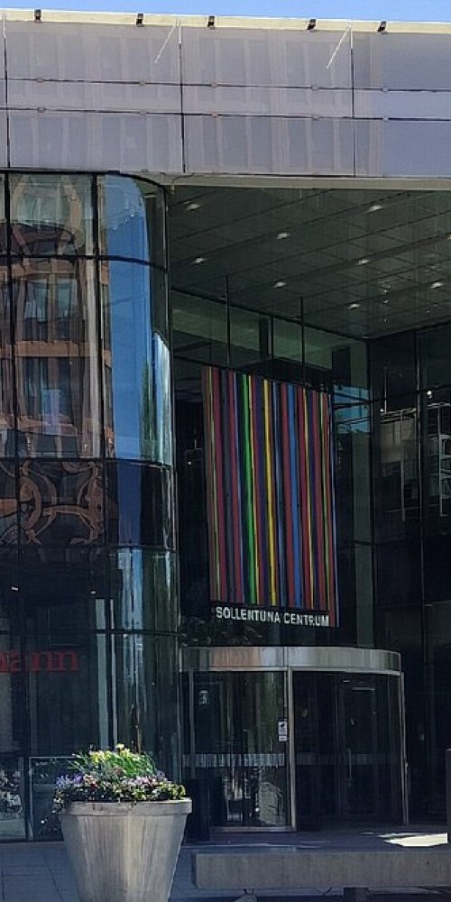 Tram navigating Sollentuna streets in soft light