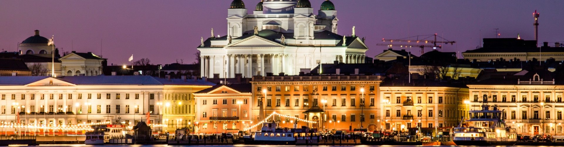 Night tram gliding over Helsinki cobblestone street