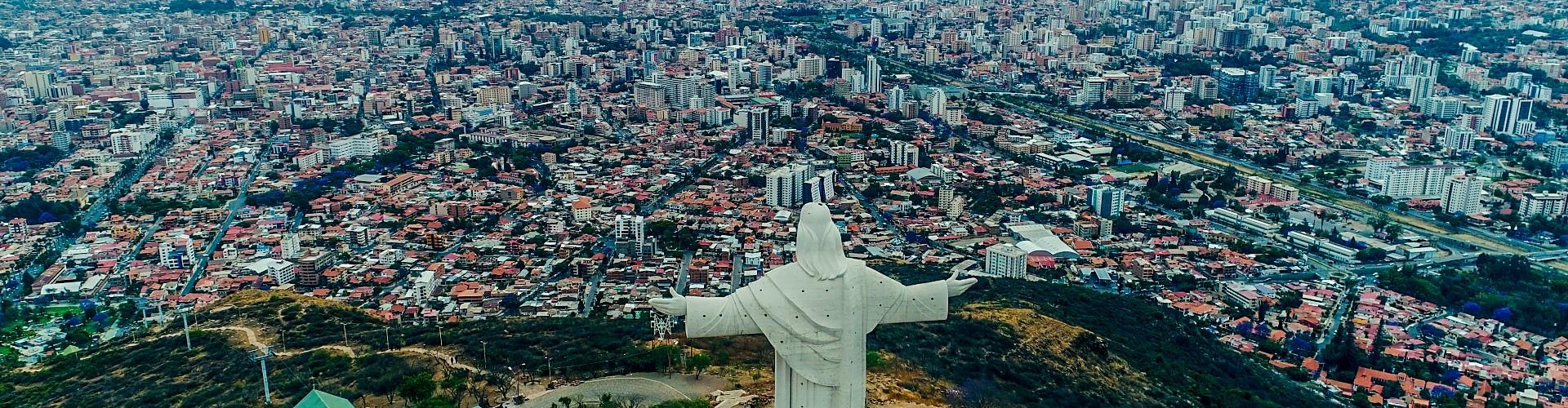 Busy Cochabamba street with tram and passengers