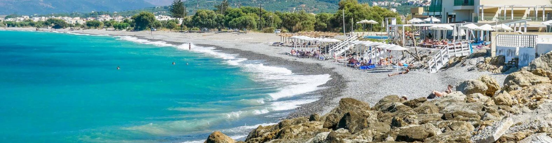 Kolimvari Central Station with trams and commuters