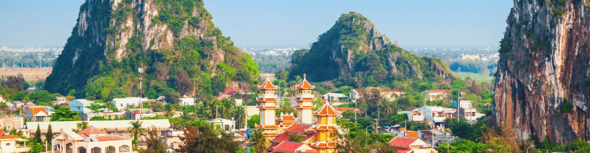 Night tram softly glowing on cobblestone street in Da Nang