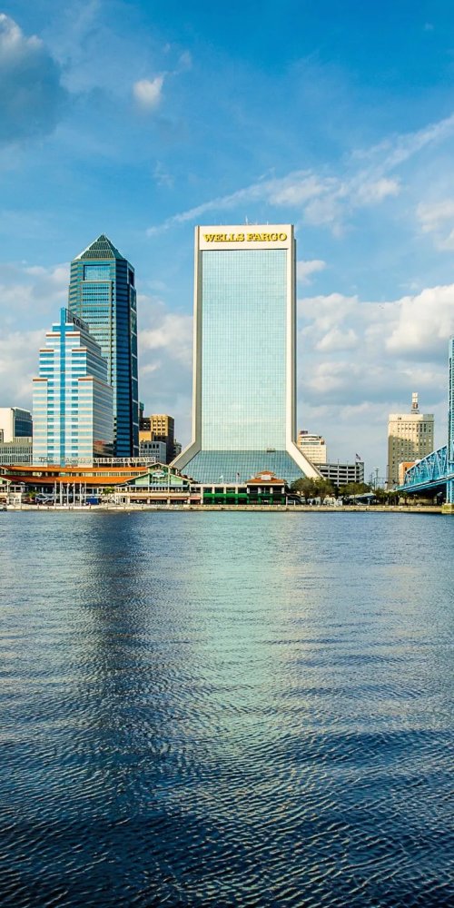 Passenger boarding tram during sunset