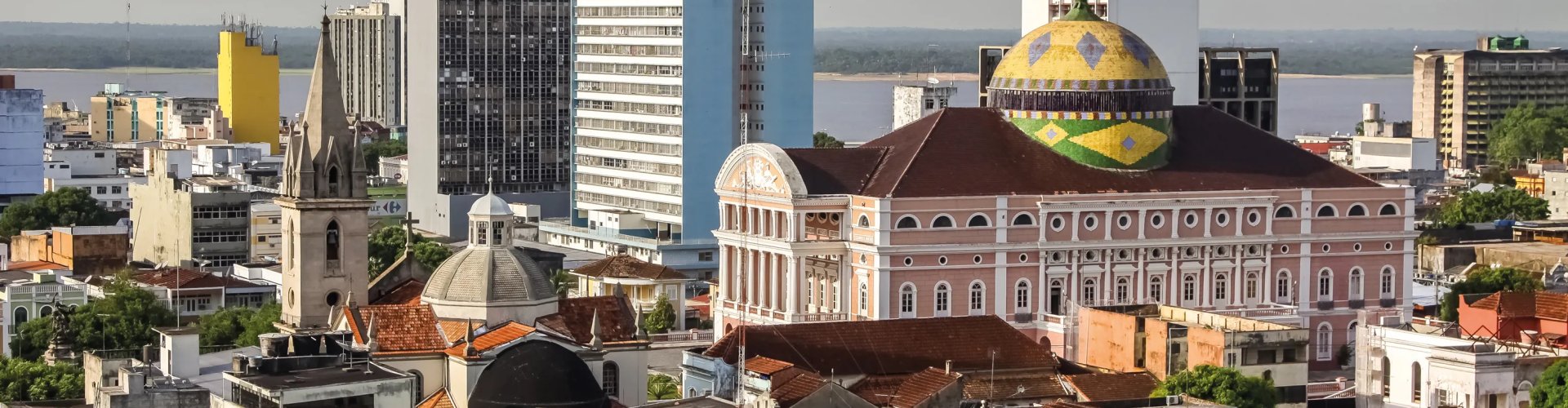 Busy Manaus Central Station with commuters and public transport
