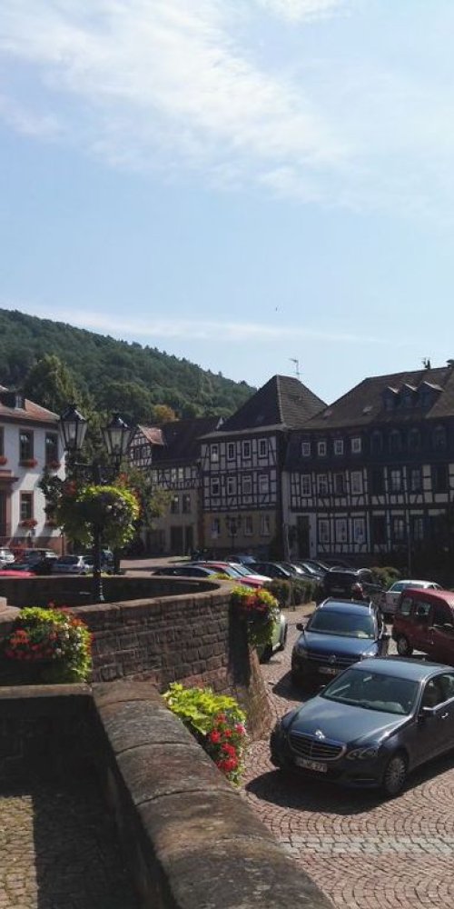 Tram passing historic buildings in Gelnhausen