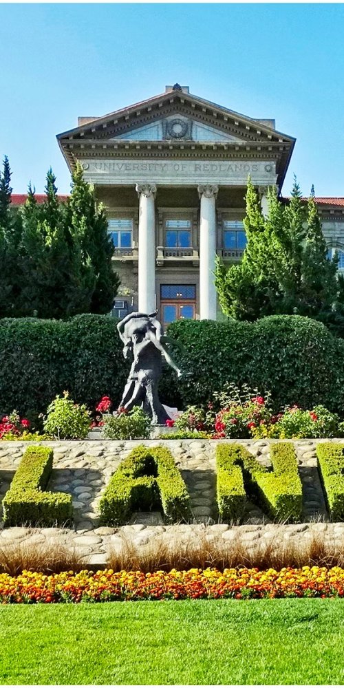 Tram moving past city streetlights at dusk