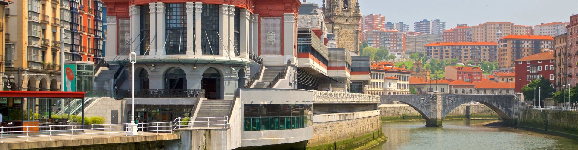 Night tram gliding over Bilbao's cobblestones