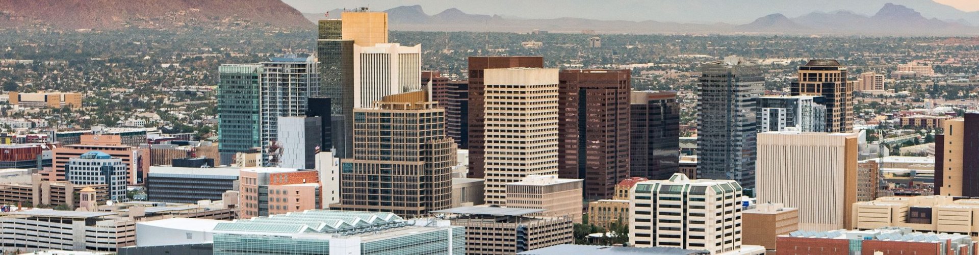 Busy Phoenix tram station with passengers boarding