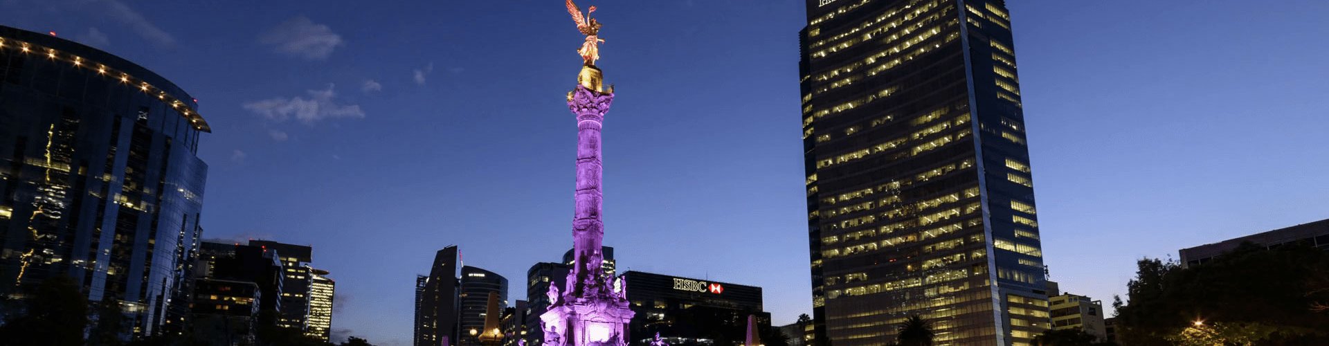Night tram gliding down a cobblestone street in Mexico City