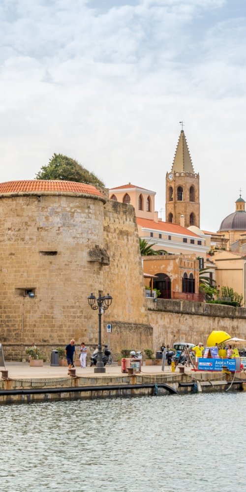 Alghero tram passing historic buildings
