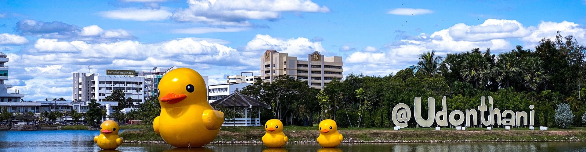 Night tram gliding on cobblestones in Udon Thani
