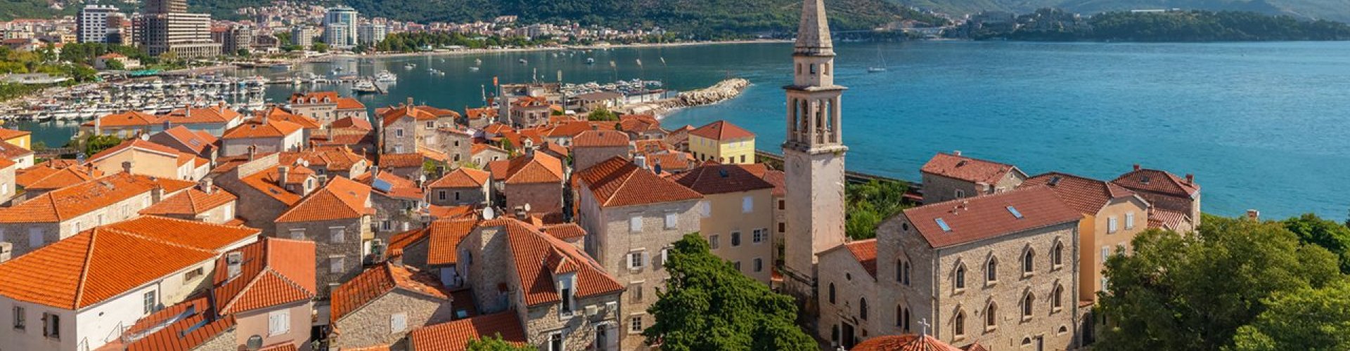 Budva city tram passing a seaside street
