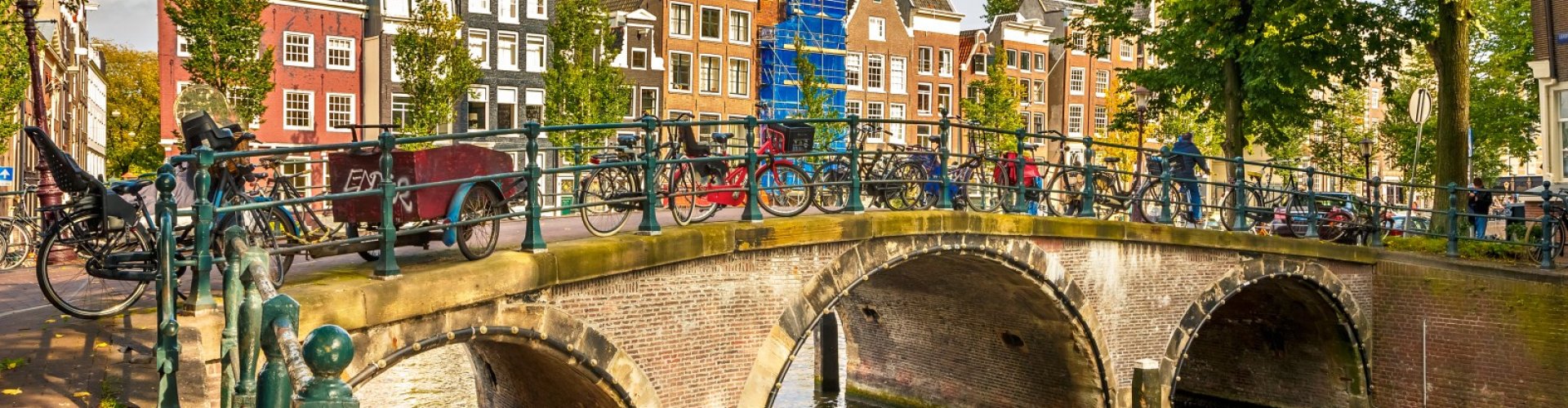 Night tram on cobblestone street in Amsterdam