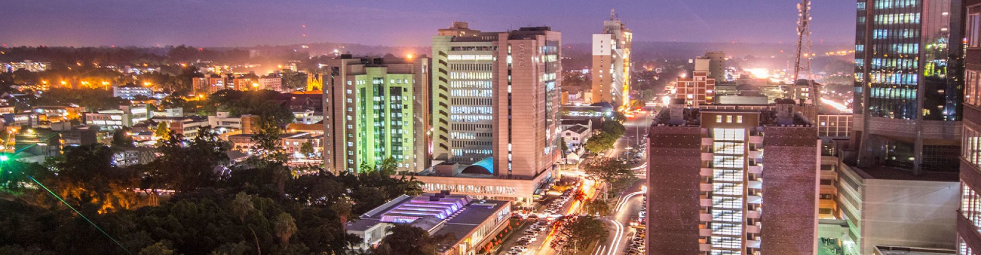 Night tram illuminated on cobblestone street in Harare