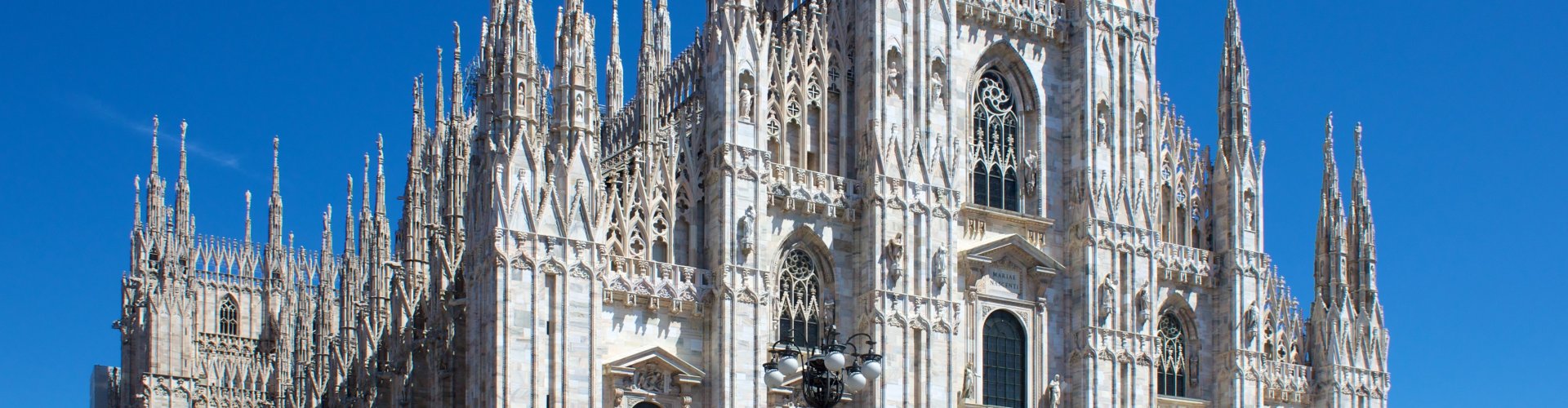 Night tram gliding over cobblestones in Milan