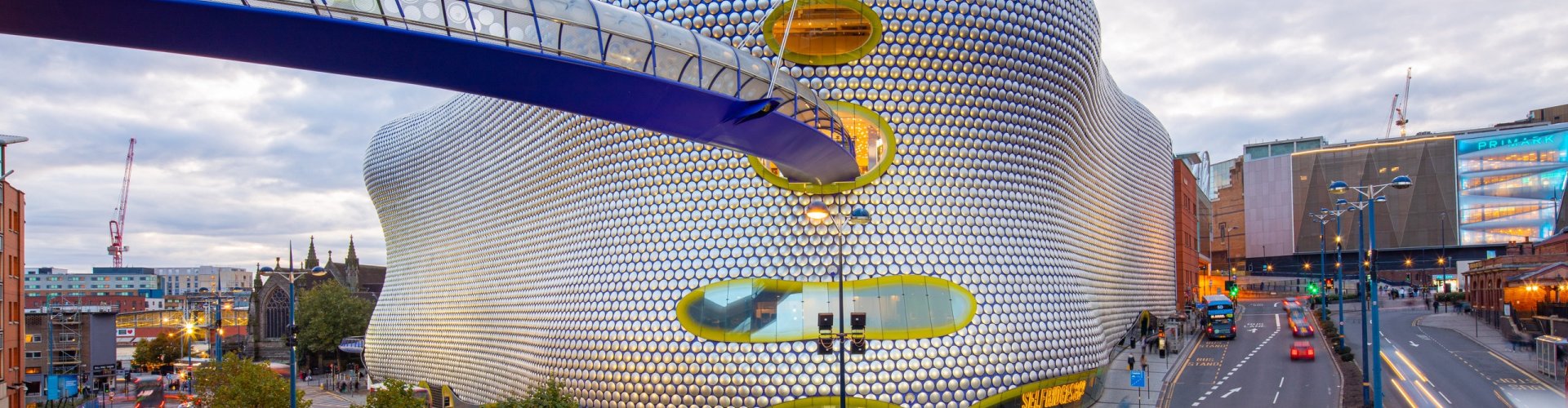 Night tram gliding on cobblestones in Birmingham