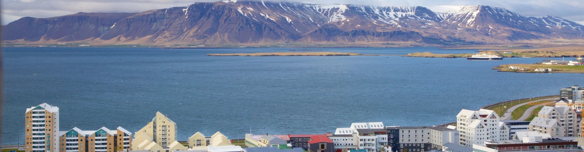 Night tram gliding on cobblestone street in Reykjavík