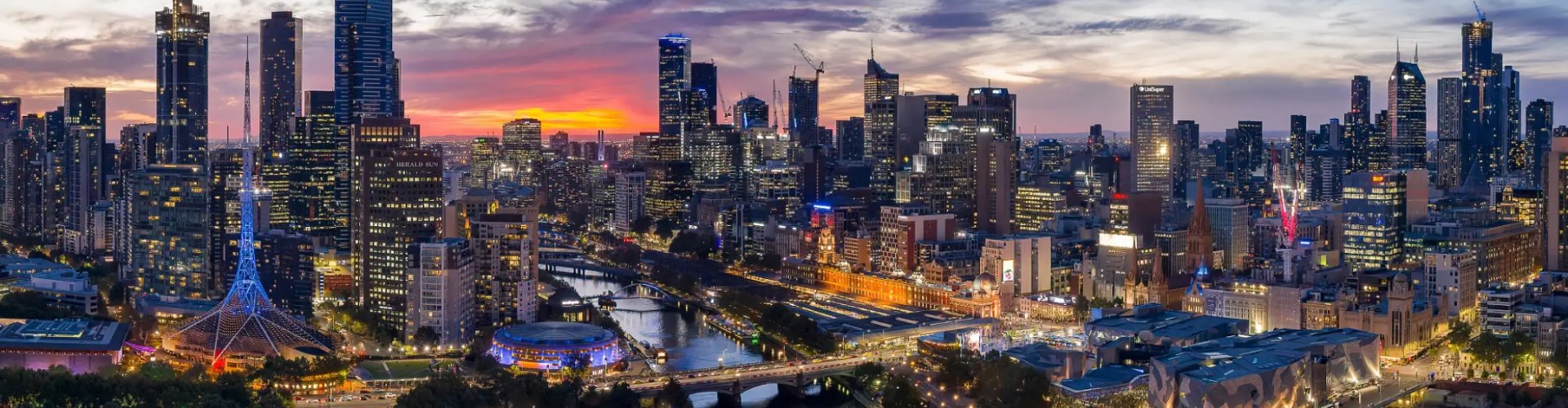 Night tram gliding over cobblestone street in Melbourne