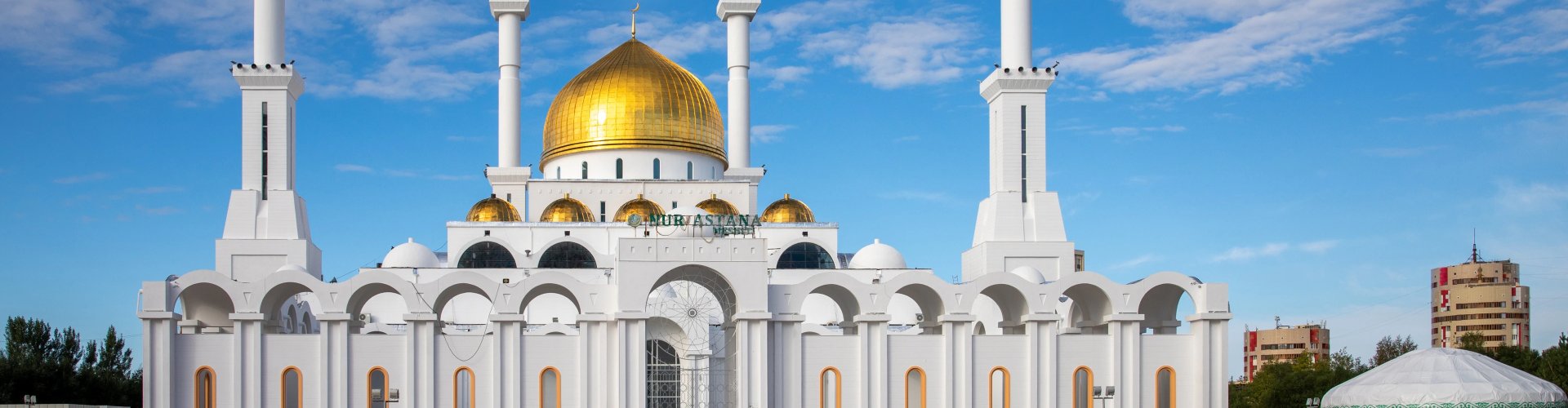 Night Tram on Cobblestone Street in Astana