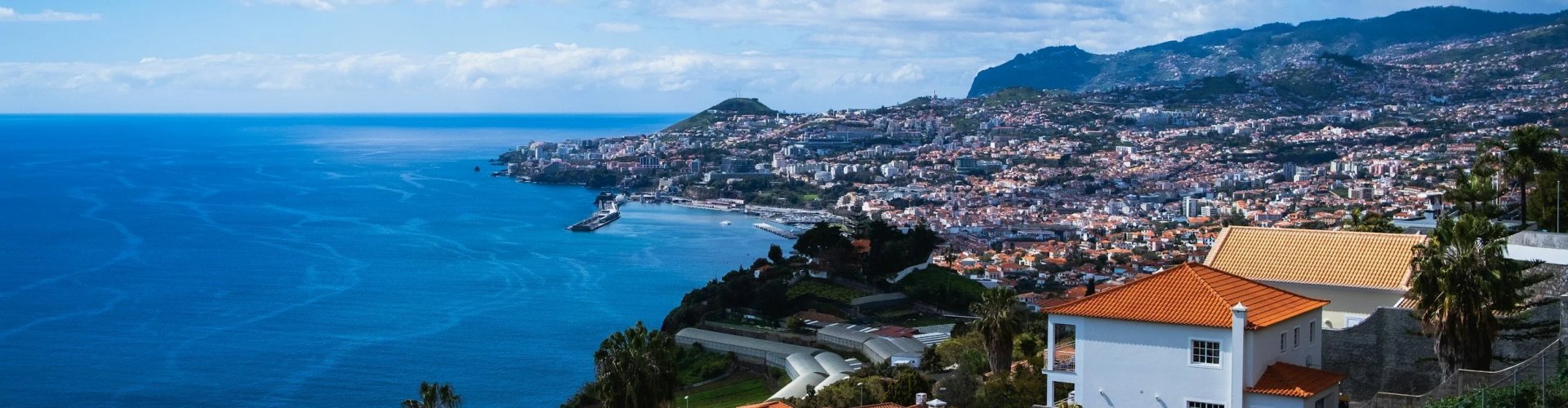 Night tram gliding over cobblestones in Funchal