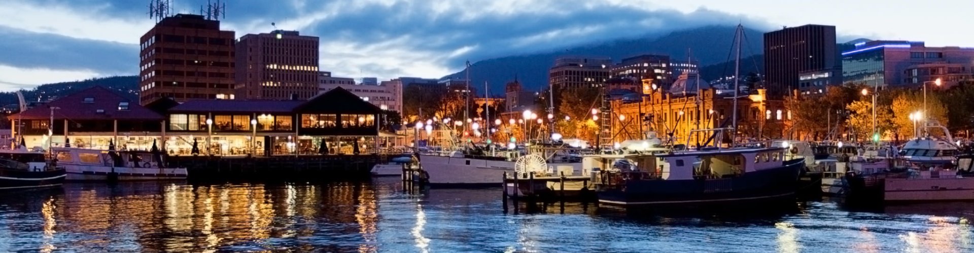 Night tram passing cobblestones in Hobart