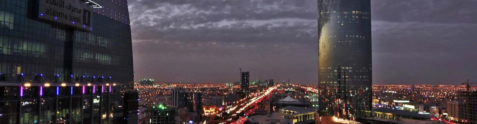 Night tram flickering lights on cobblestone street in Riyadh