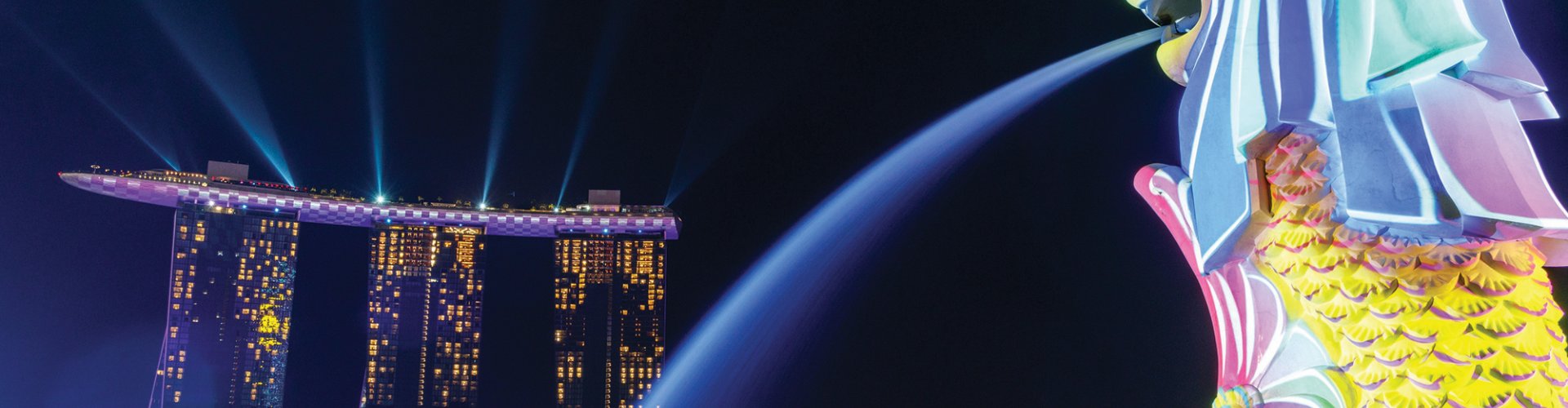 Night-time tram gliding over cobblestones in Singapore