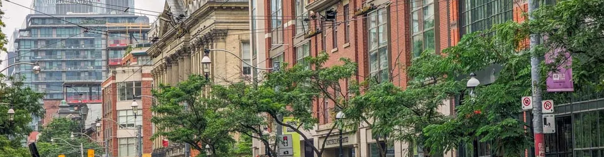 Toronto streetcar alongside skyscrapers