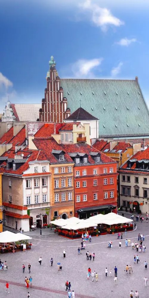 Commuters waiting at Warsaw tram stop during rush hour