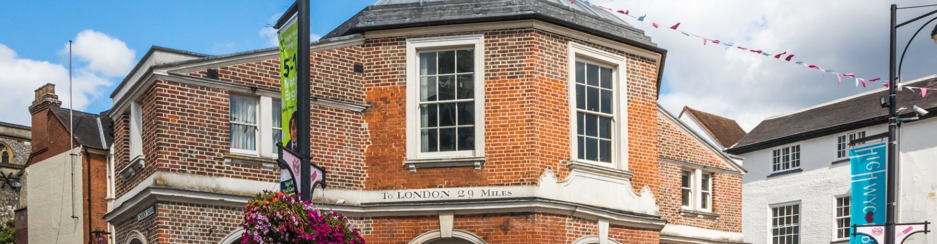 Night tram gliding over cobblestone street in High Wycombe