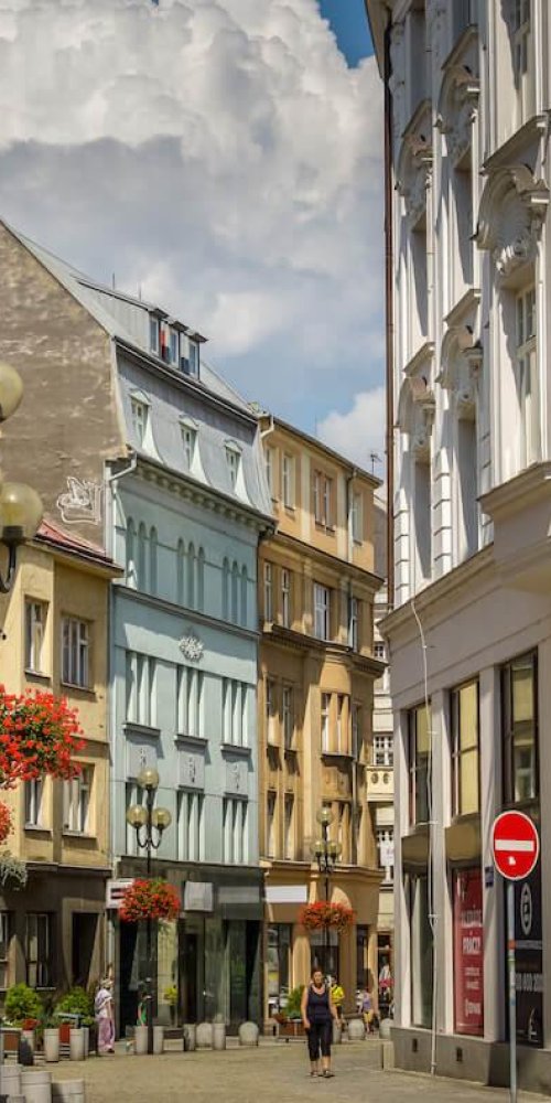 Passenger boarding tram in Ostrava with bright cityscape
